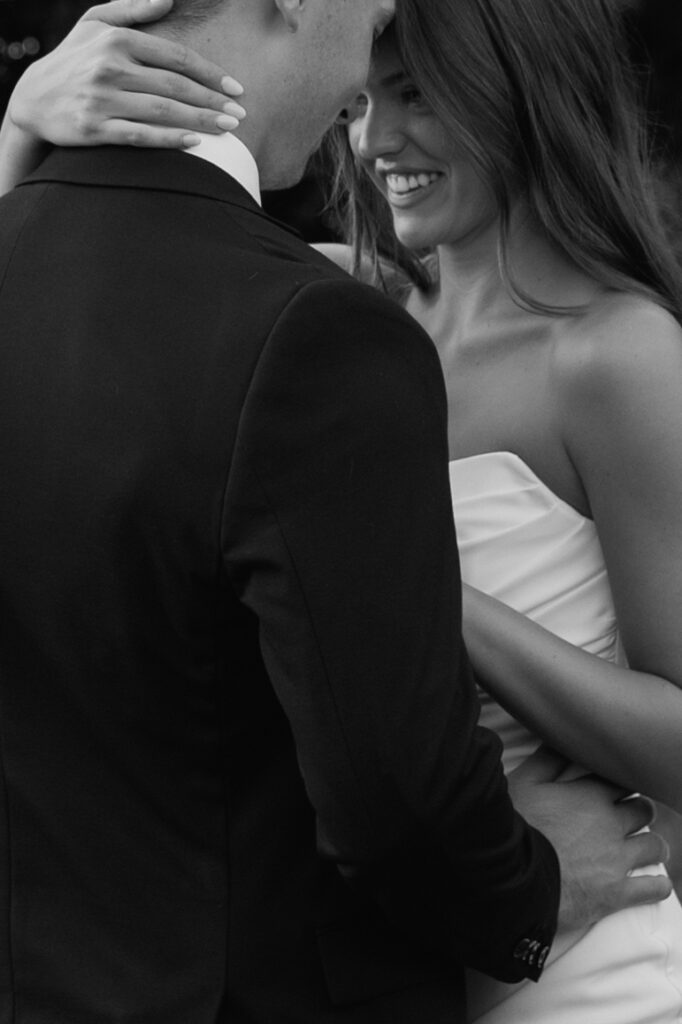 Close-up documentary wedding photo of bride and groom sharing a quiet, emotional moment in Fargo ND