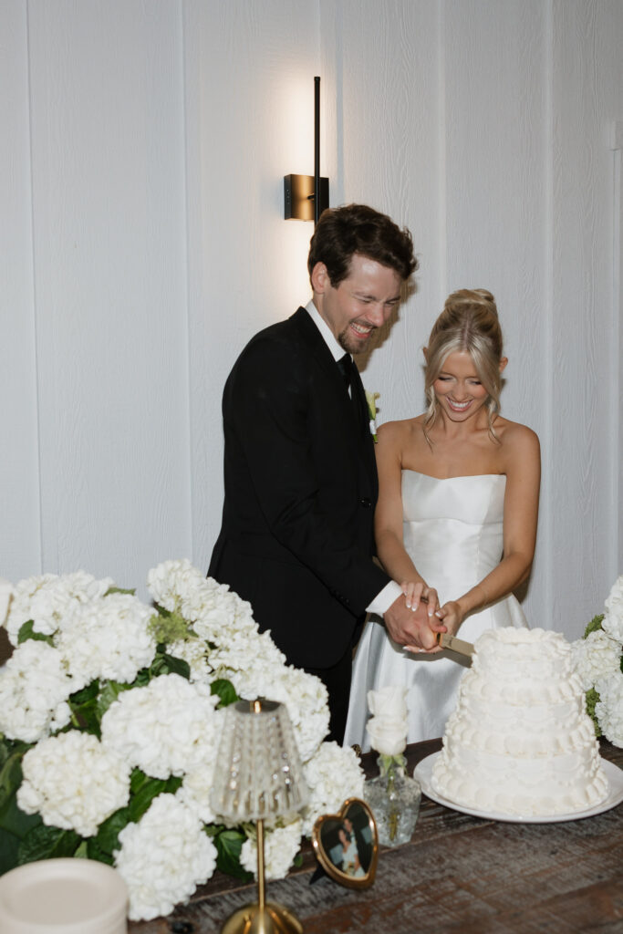 Bride and groom | cutting wedding cake together | wedding reception